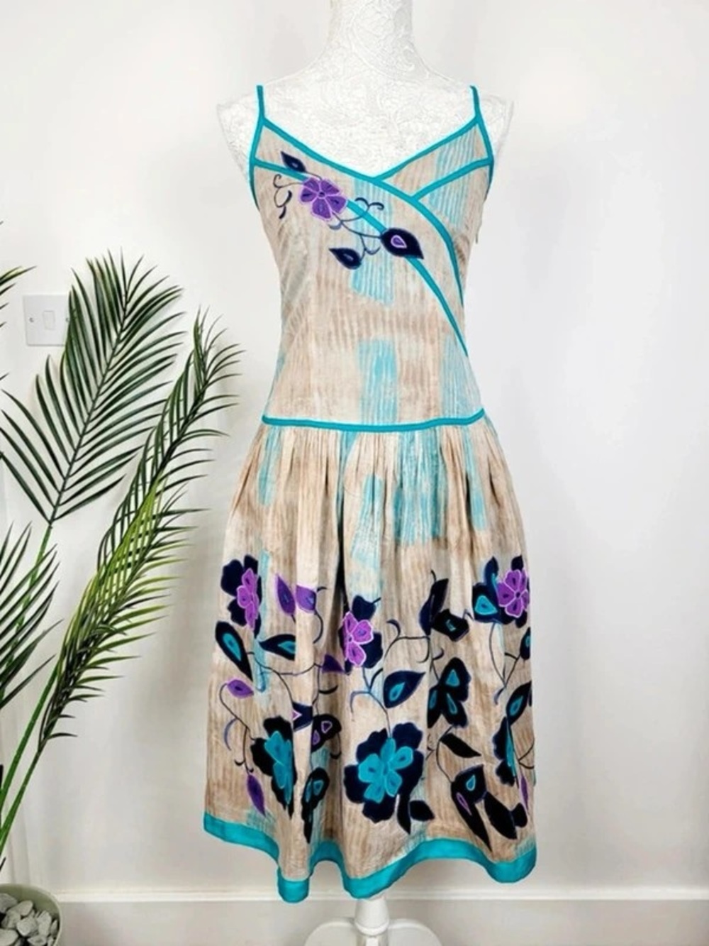 Beige Maxi Dress with Teal Trim and Purple Floral Accents